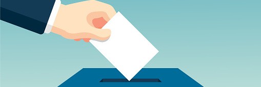 Ein Zettel wird in eine Wahlurne geworfen