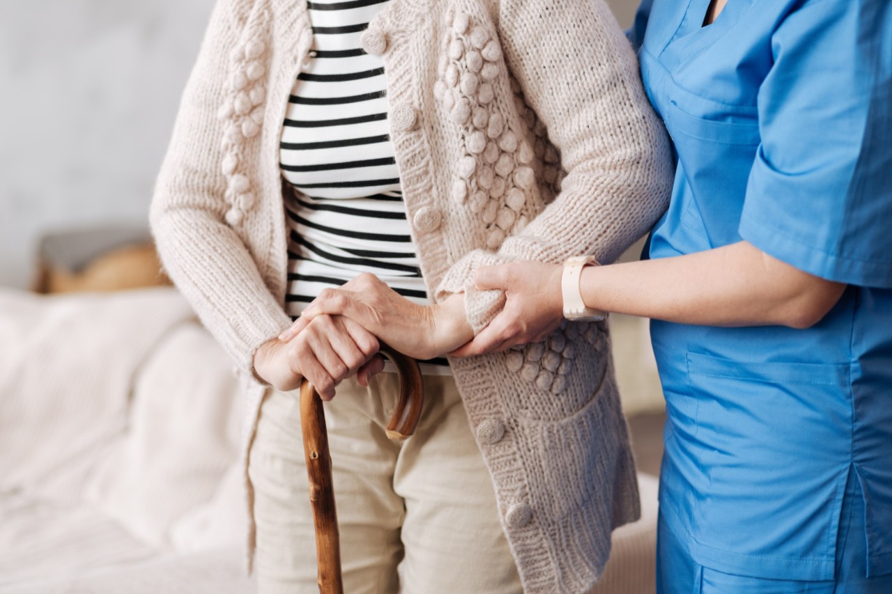 Gentle trained nurse helping mature patient