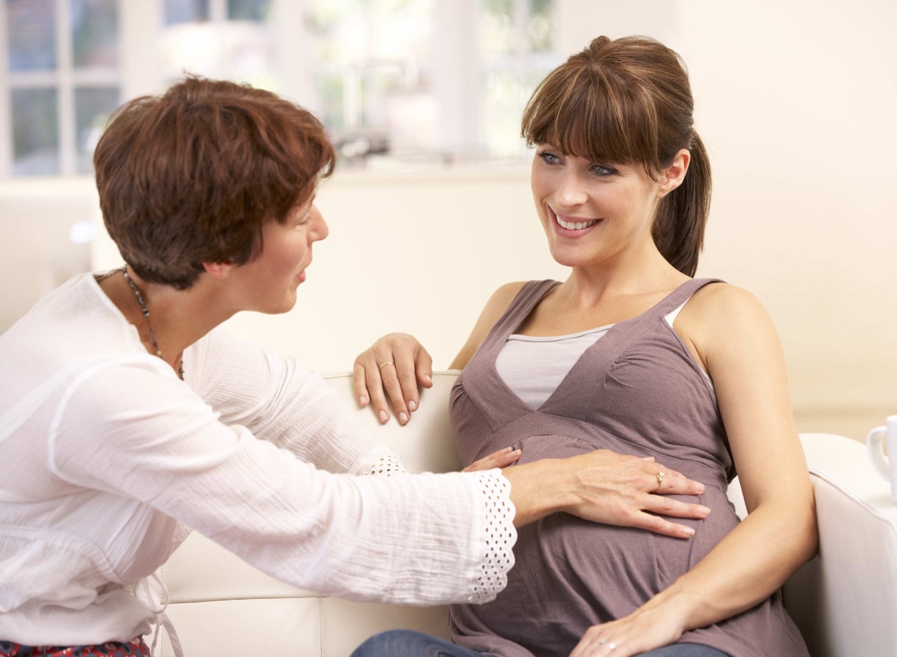 Pregnant woman talking to midwife