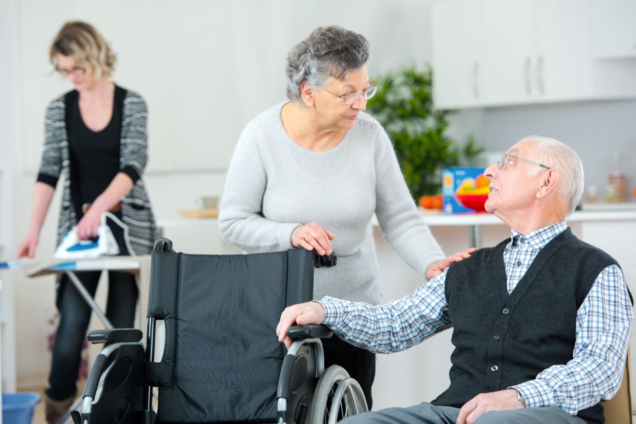 old couple talking while being assisted