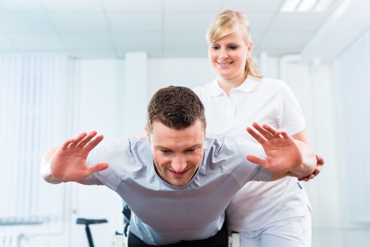 Physiotherapist or sport doctor with patient Physiotherapist or sport doctor with patient