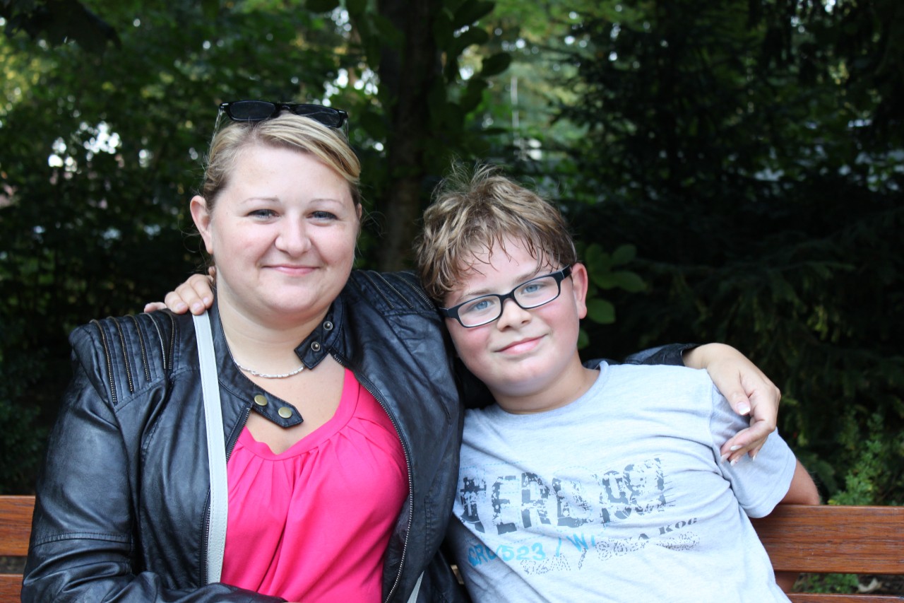 Mutter und Sohn auf einer Bank in der Natur