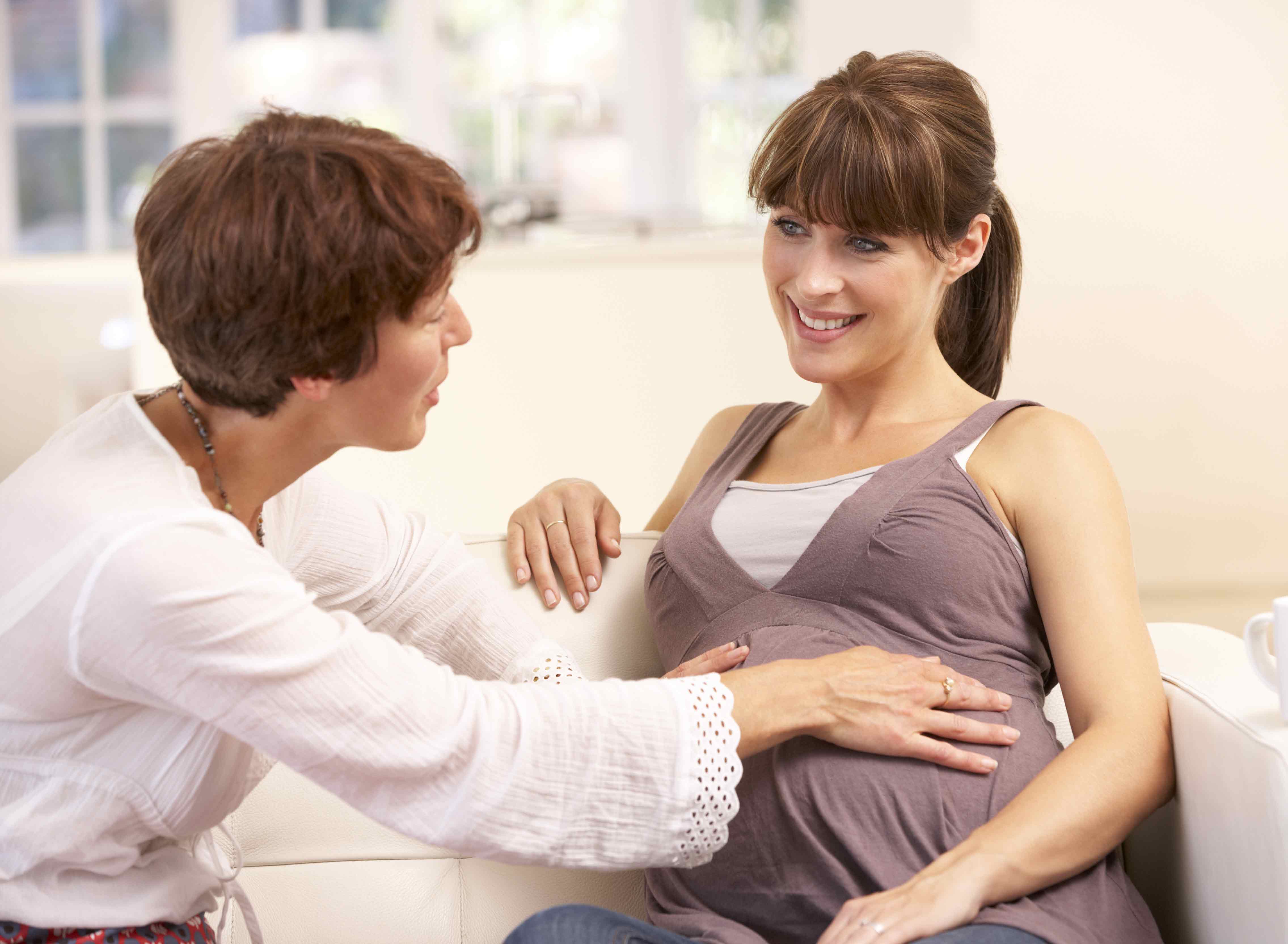 Hebamme spricht mit schwangerer Frau